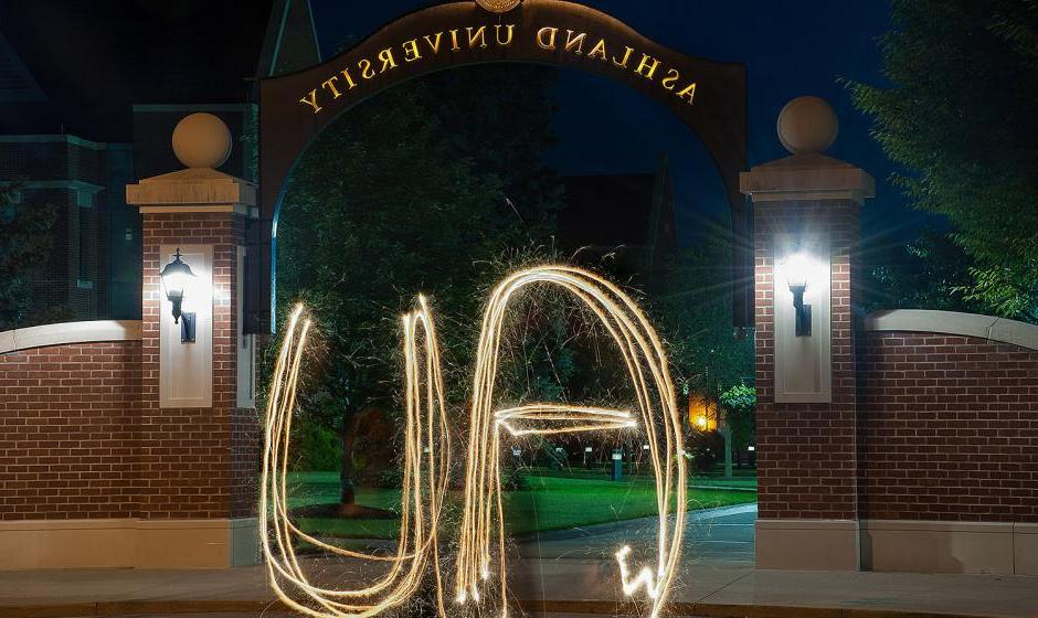 AU spelled out with sparkler in front of arch